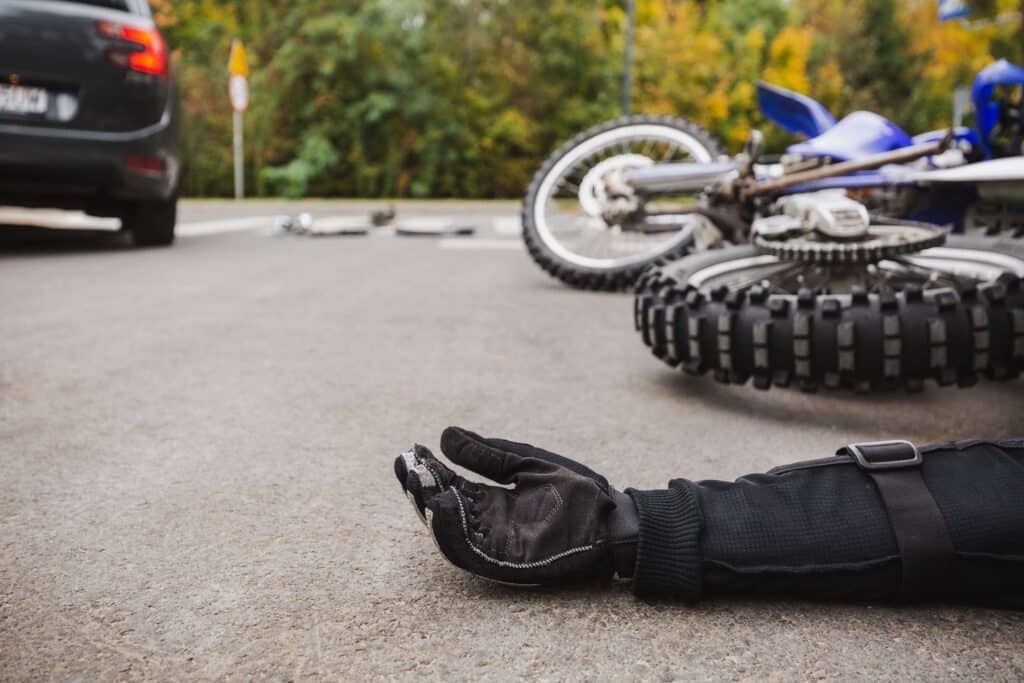 Person on the ground after being involved in a motorcycle accident