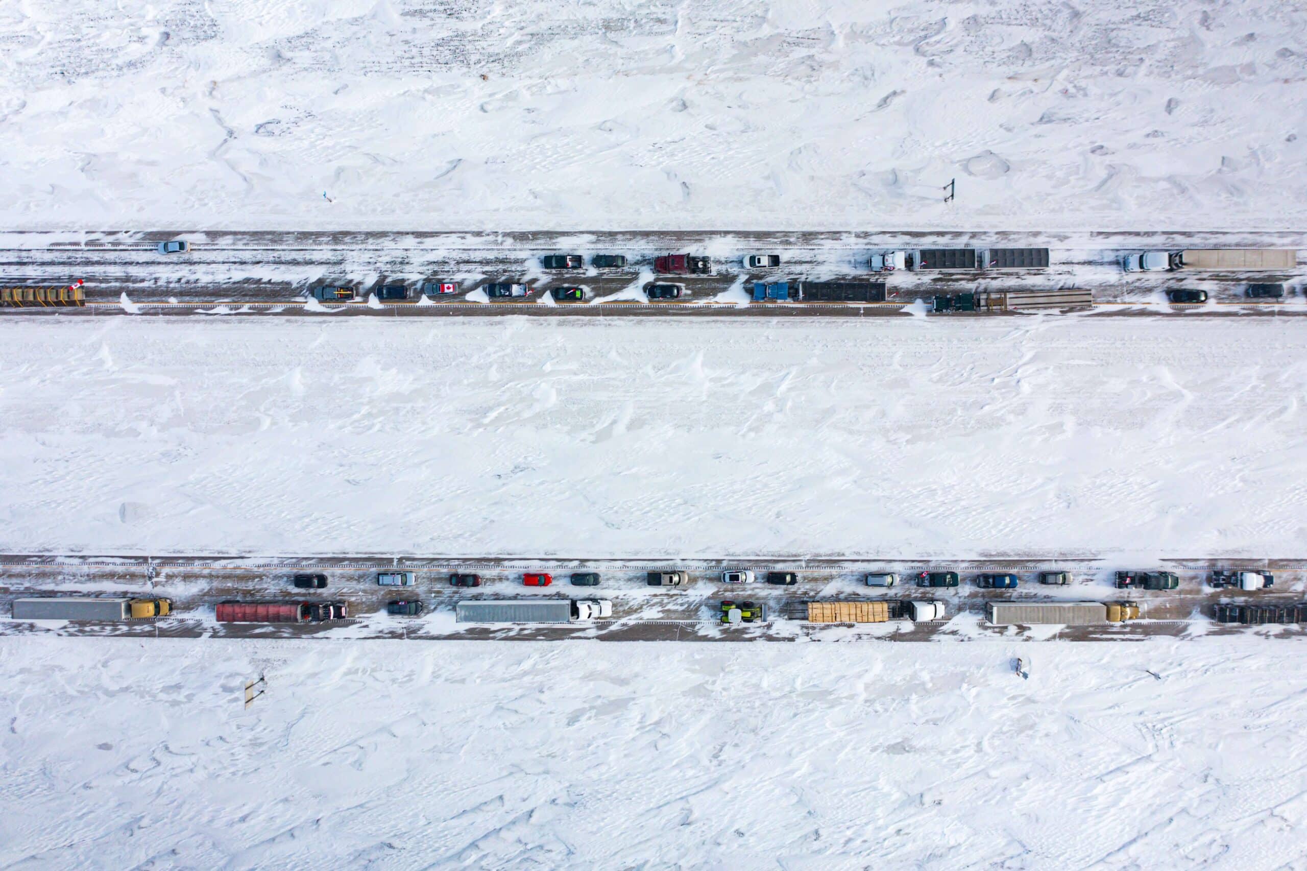 Aerial view of traffic on a freeway during a snowstorm